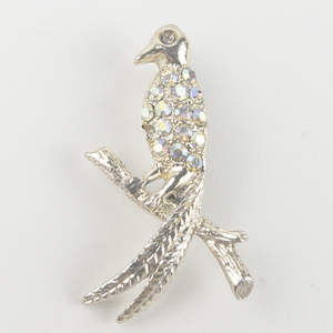 lot 232 image: Tropical Bird With Aurora Borealis Rhinestones White Base Metal Brooch .