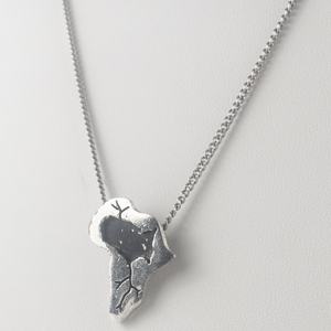 lot 376 image: Sala 1972  Vintage Africa & USA Heart Beat Silver Tone Base Metal Pendant Necklace .