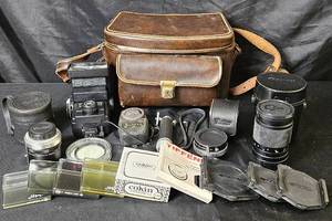 lot 127 image: Collection of Vintage Camera Accessories. Lenses, light meter, Vivitar Flash, lens covers and much more