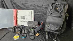 lot 27 image: Lumix GH4 Digital Camera With Many Extras. Lenses, extra batteries, light meter, shotgun microphone and Lowepro carry bag.