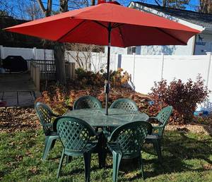 lot 254 image: Green Wrought Iron Patio Table, 6 Plastic Green Chairs with Umbrella and Stand