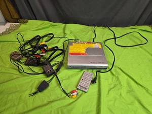 lot 16 image: Coby Portable DVD Player with Remote and Cables