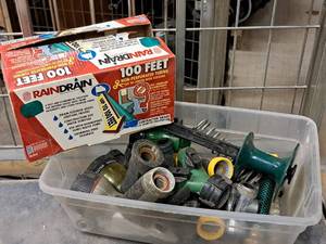 lot 765 image: Lot of (1 Tote) Assorted Water Hose Nozzles, Hose Guide, Rain Drain Non-Perforated Tubing Contractor Grade