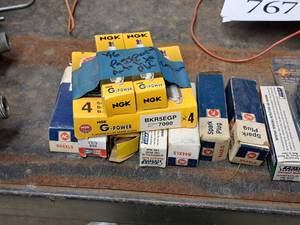 lot 766 image: Lot of (14) Assorted Spark Plugs and Bulbs - AC R44XLS,1996 Passport NGK BKR5EGP, Champion 868 RJ19LM, Feit Electric 120V100W Halogen