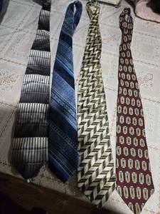 lot 29 image: Four High Profile Brand Neckties( Mandmade Dimoggio Gold Weises by Beau Brummell Bachrach, and GG Neckties)