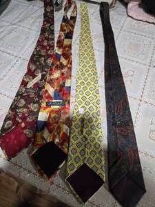 lot 35 image: Four High Profile Brand Neckties ( Valentino, Caravaggio Pure Silk Italian Silk, GG, and Envoy All Silk Neckties)