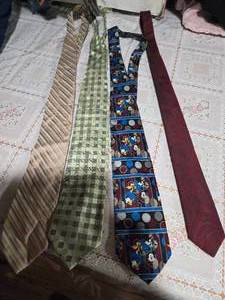lot 36 image: Four High Profile Brand Neckties (Calvin Klein, Valerio Garati Oure Silk, Mickey Limited Disney, and Stringbeans Neckties)