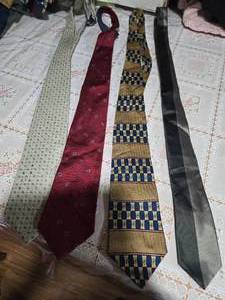 lot 40 image: Four High Profile Brand Neckties  ( Pierre Cardin, Tommy Hilfiger, Perry Ellis, and an unbranded Necktie)