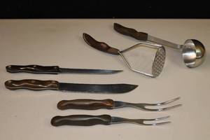 lot 231 image: CutCo Cutlery 13-Inch Butcher Knife, 12-Inch Serrated Knife, Soup Ladle, 10.5 & 11.5 Meat Forks, 10.5 Potato Masher