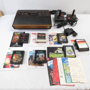lot 8 image: Model CX-2600 Atari Console - Controllers, Games & Pamphlets