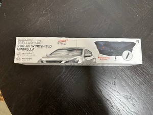 lot 81 image: New Sharper Image Brella Shade Pop up Windshield Umbrella to Protect Car Interior or Good Useless Gift  )