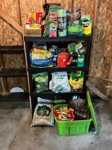 lot 170 image: Black Shelf with all Garden and Yard Maintenance Fertilizer Items