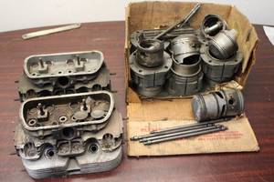 Collection of Vintage Motorcycle Engine Components including Cylinders and Pistons