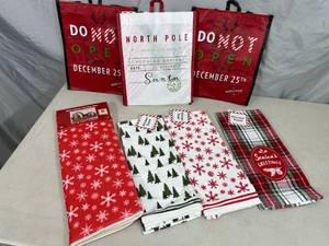 lot 215 image: New Holiday Themed Gift Bags, Kitchen Towels, Dish Mat