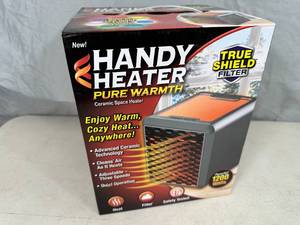 lot 235 image: New Handy Heater Pure Warmth Ceramic Space Heater with LED Lights