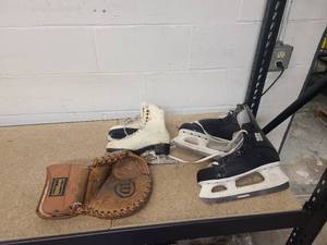 lot 30 image: 2 pairs ice skates and a goalie glove