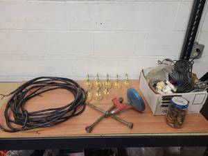 lot 41 image: 14-3 electrical wire, plumbing snake, tire iron, 8 coat hooks (7 with wooden trim), and a box of misc plumbing items