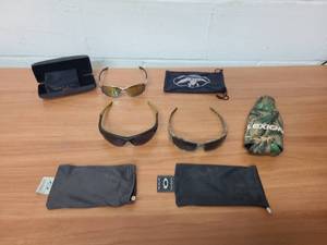 lot 46 image: 3 pairs of sunglasses and a camo bottle koozie