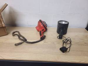 2 hand held lights 1 12 volt plug in and 1 researchable