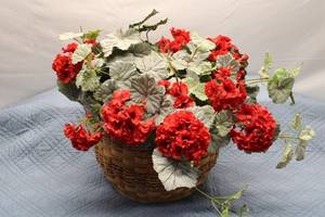 lot 31 image: Artificial Red Geranium Plant in Decorative Woven Basket