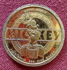 lot 38 image: 1997 Disney 14 oz Silver Round