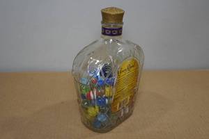 lot 251 image: Marbles in a Crown Royal Bottle