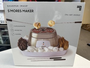 lot 99 image: Sharper Image Electric Smores Maker Safely roast marshmallows and make smores right in your kitchen with Tray.