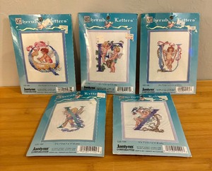 lot 161 image: Five New Janlynn Cherub Letter Needlepoint Kits