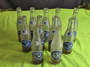 lot 4 image: Collection of 11 Vintage M&S Mellow and Smooth Soda Bottles - Glass Soft Drink Bottles