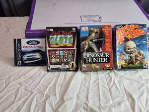 lot 35 image: Lot of 4 PC and PS1 Video Games Ford Racing, Reel Deal Slots, Dinosaur Hunter, Chicken Little