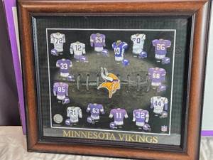 lot 161 image: Framed Minnesota Vikings Jerseys Display with Helmets 8 inches wide by 16.5 inches tall.