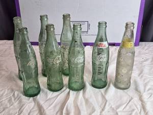 lot 199 image: Collection of 8 Vintage Glass Soda Bottles including Coca-Cola and Diet Coke