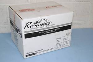 lot 69 image: New in Box Rockustics EconoRock Weatherproof Outdoor Landscaping Audio Loudspeaker Speaker - Brown