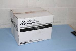 lot 70 image: New in Box Rockustics EconoRock Weatherproof Outdoor Landscaping Audio Loudspeaker Speaker - Brown