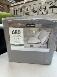 lot 207 image: Kirkland Signature 680 Thread Count Sheet Set - Grey - King - New DAMAGED - Cut through part in package open see pictures