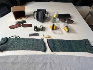 lot 289 image: Lot of Vintage Safety Gear and Accessories Including Protective Gun Sleeves, Gun Oil, and Sunglasses