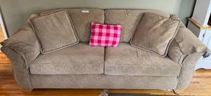 lot 204 image: Large Beige Couch with Decorative Pink Pillow