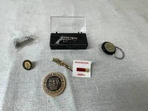 lot 38 image: Shooting Themed Pins, Clips, Keychains and Wooden Nickel