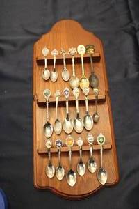 lot 104 image: Collection of 27 Vintage Souvenir Spoons Displayed on Wooden Rack