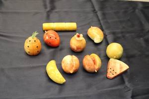 lot 109 image: Set of 10 Handcrafted Fruit Carvings in Various Colors and Designs