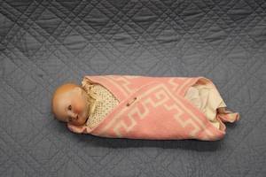 lot 59 image: Vintage Wrapped Porcelain Doll with Pink Blanket