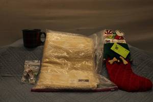 lot 94 image: Holiday Pet Stocking, Plaid Mug, and Decorative Placemat Set
