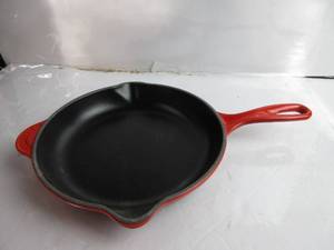 lot 43 image: Le Creuset Classic Cast Iron Handle Skillet, 9, Cerise HAS SCRATCHES ON BOTTOM, LIKE NEW