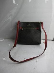 lot 62 image: NWT Coach Signature PVC Crossbody Brown  Carmine SOME OF LEATHER ALONG ZIPPER IS OFF, ZIPPER SCRATCHED, A BIT STAINED INSIDE MIGHT BE ABLE TO CLEAN OFF , HAS A USED SMELL, USED