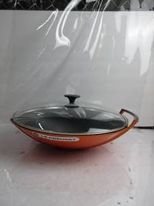 lot 77 image: Le Creuset Enameled Cast-Iron 14-14-Inch Wok with Glass Lid, Flame MISSING 1 HANDLE, BROKEN HANDLE, LID A BIT WOBBLY,  NEW