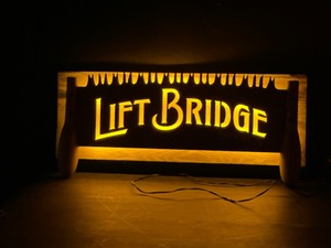 lot 157 image: Lift Bridge wood light up sign with metal saw blade