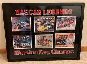 lot 4 image: NASCAR Legends Framed Behind Glass Winston Cup Champs Signed By Gordon, Wallace, Petty, Waltrip, Jarrett & Elliott 34 x 44
