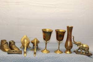 Collection of Brass Decorative Items Including Goblets, Ducks, and Vintage Baby Shoes
