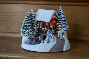 lot 33 image: Vintage Christmas Village Scene with Skaters and Horse-Drawn Carriage