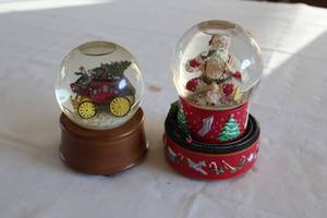 lot 75 image: Lot of 2 Holiday Snow Globes - Santa and Horse-Drawn Carriage Designs